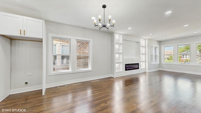 7545 S Perry Ave, Chicago, IL 60620 - unfurnished living room with a chandelier, dark wood-style flooring, recessed lighting, baseboards, and a glass covered fireplace