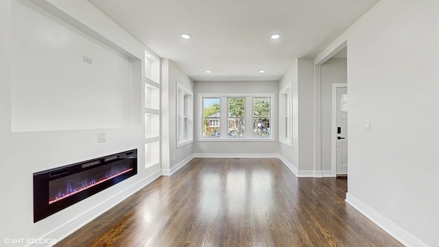 7545 S Perry Ave, Chicago, IL 60620 - unfurnished living room with a glass covered fireplace, dark wood finished floors, baseboards, and recessed lighting
