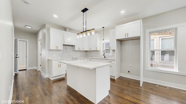 7545 S Perry Ave, Chicago, IL 60620 - kitchen with decorative backsplash, white cabinetry, dark wood finished floors, and recessed lighting