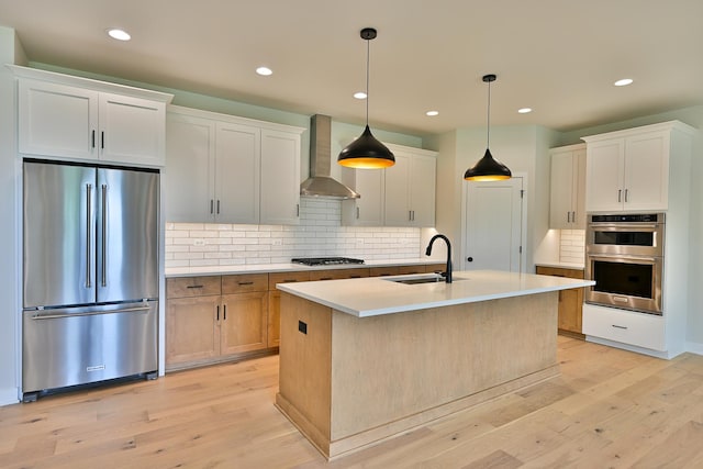 1568 Dempsey Dr, Saint Charles, IL 60174 - kitchen with appliances with stainless steel finishes, wall chimney exhaust hood, backsplash, light countertops, and light wood-type flooring