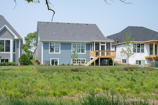 1568 Dempsey Dr, Saint Charles, IL 60174 - rear view of property featuring a sunroom, stairs, roof with shingles, and a lawn