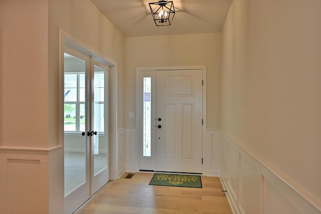 1568 Dempsey Dr, Saint Charles, IL 60174 - foyer with light wood-style floors, a wainscoted wall, and a decorative wall