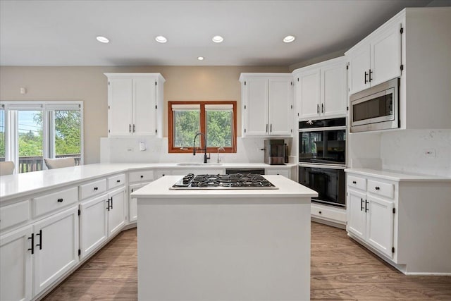 670 Leslie Ct, Carol Stream, IL 60188 - kitchen featuring a sink, stainless steel appliances, white cabinetry, and recessed lighting