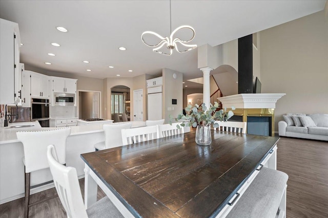 670 Leslie Ct, Carol Stream, IL 60188 - dining area with arched walkways, decorative columns, a chandelier, dark wood-type flooring, and recessed lighting