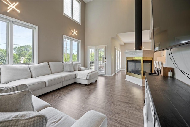 670 Leslie Ct, Carol Stream, IL 60188 - living room featuring a high ceiling, dark wood-style flooring, a multi sided fireplace, and baseboards