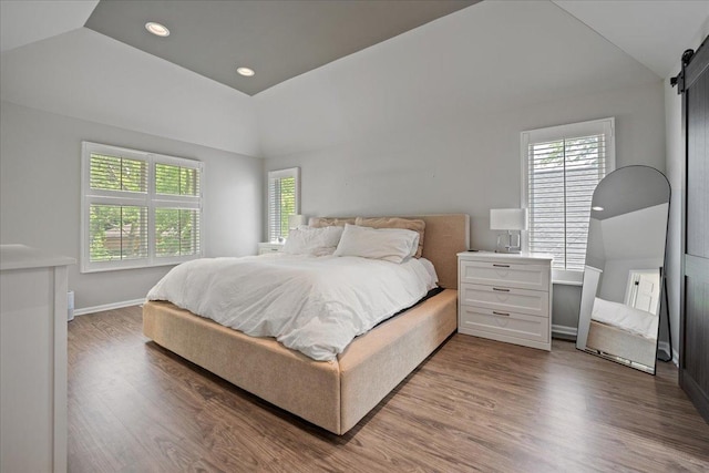 670 Leslie Ct, Carol Stream, IL 60188 - bedroom with multiple windows, a barn door, vaulted ceiling, wood finished floors, and recessed lighting
