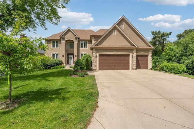 670 Leslie Ct, Carol Stream, IL 60188 - view of front of house featuring a front yard, concrete driveway, a garage, and stucco siding