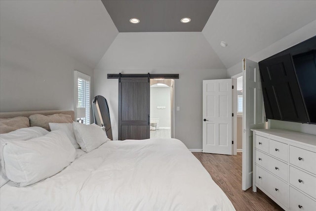670 Leslie Ct, Carol Stream, IL 60188 - bedroom featuring vaulted ceiling, dark wood-style flooring, a barn door, recessed lighting, and ensuite bathroom