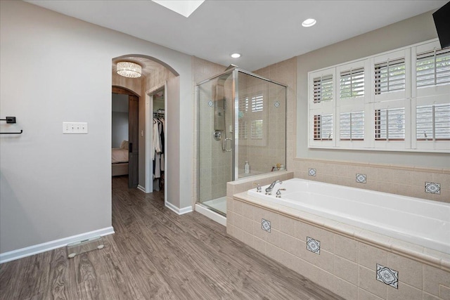 670 Leslie Ct, Carol Stream, IL 60188 - full bath featuring a spacious closet, a garden tub, a shower stall, wood finished floors, and baseboards