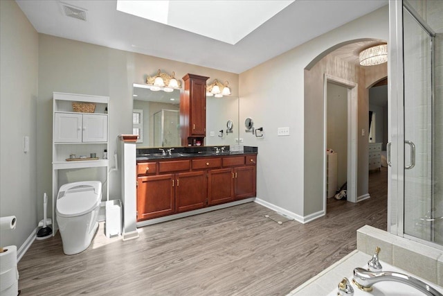 670 Leslie Ct, Carol Stream, IL 60188 - full bathroom with wood finished floors, double vanity, baseboards, a stall shower, and toilet