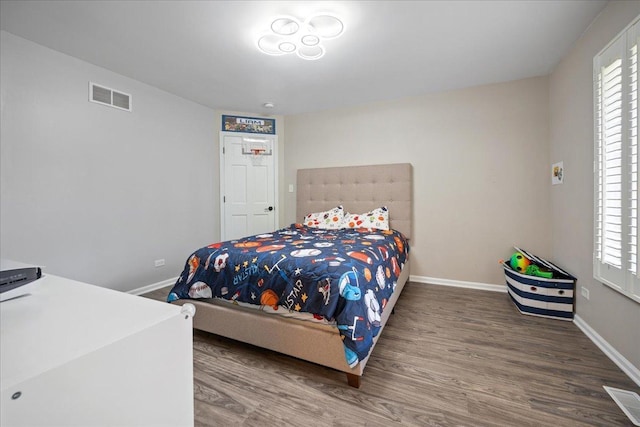 670 Leslie Ct, Carol Stream, IL 60188 - bedroom with wood finished floors, baseboards, and multiple windows
