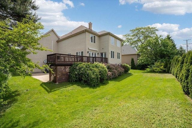 670 Leslie Ct, Carol Stream, IL 60188 - rear view of house with a deck, a chimney, and a lawn