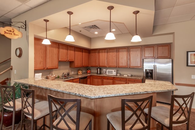 LOT37 W Caspian Cir, Lockport, IL 60441 - kitchen featuring appliances with stainless steel finishes, a peninsula, a kitchen breakfast bar, a paneled ceiling, and light stone counters