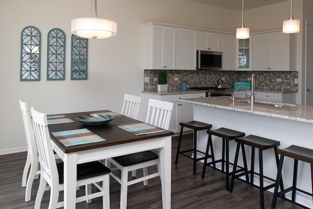 LOT37 W Caspian Cir, Lockport, IL 60441 - kitchen featuring stainless steel microwave, range, a kitchen bar, and backsplash