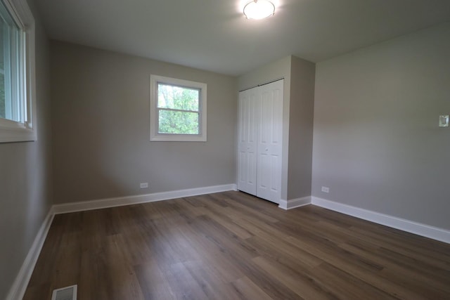 18310 Anthony Ave, Country Club Hills, IL 60478 - unfurnished bedroom featuring dark wood-style floors, a closet, and baseboards
