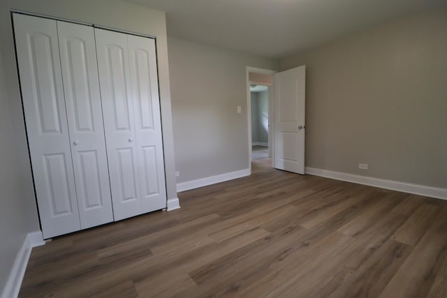 18310 Anthony Ave, Country Club Hills, IL 60478 - unfurnished bedroom featuring a closet, baseboards, and wood finished floors