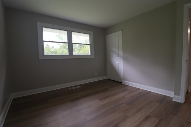 18310 Anthony Ave, Country Club Hills, IL 60478 - unfurnished bedroom featuring dark wood-style flooring, a closet, and baseboards