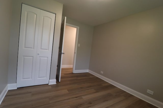 18310 Anthony Ave, Country Club Hills, IL 60478 - unfurnished bedroom featuring dark wood-style flooring, baseboards, and a closet