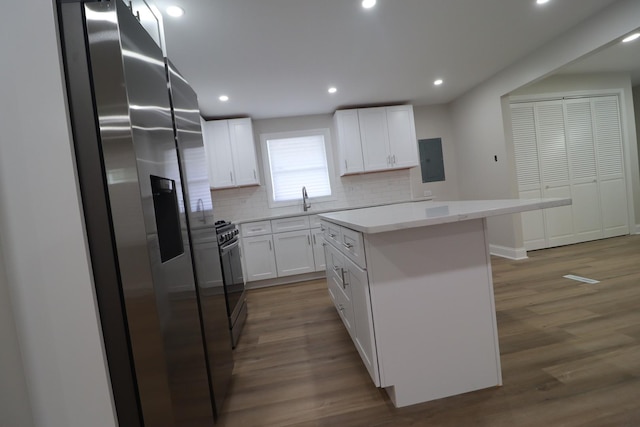 18310 Anthony Ave, Country Club Hills, IL 60478 - kitchen featuring stainless steel fridge with ice dispenser, electric panel, a center island, white cabinets, and tasteful backsplash