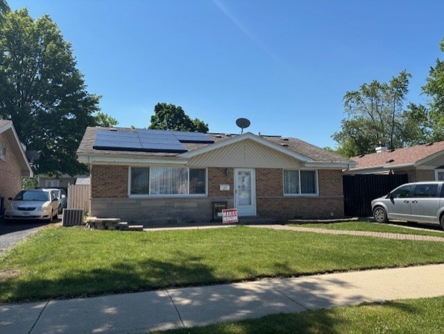 3641 W 120th Pl, Alsip, IL 60803 - view of front of property with roof mounted solar panels, a front yard, brick siding, and central AC unit
