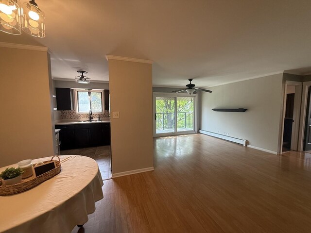 10940 S Worth Ave Unit 9, Worth, IL 60482 - dining space featuring a baseboard radiator, ceiling fan, ornamental molding, plenty of natural light, and wood finished floors