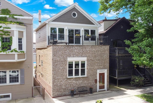 2637 W Huron St, Chicago, IL 60612 - rear view of property with brick siding, a balcony, and a gate