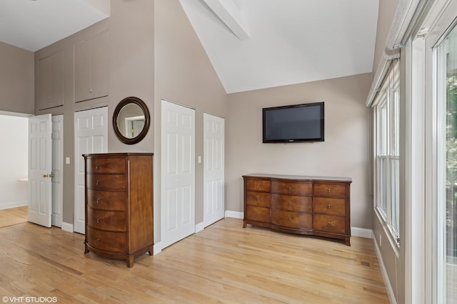 2637 W Huron St, Chicago, IL 60612 - bedroom featuring high vaulted ceiling, light wood-style floors, baseboards, and two closets
