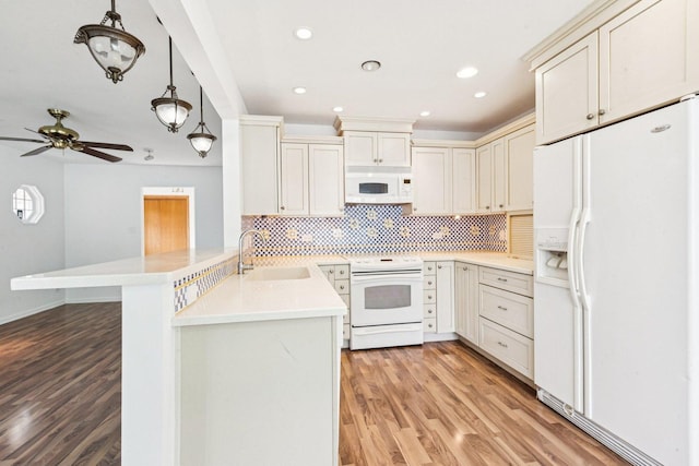 1946 Briarcliffe Blvd, Wheaton, IL 60189 - kitchen featuring white appliances, a peninsula, light wood-style floors, decorative backsplash, and light countertops