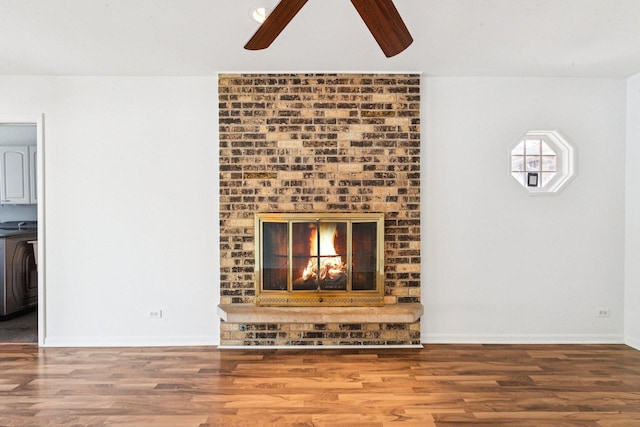1946 Briarcliffe Blvd, Wheaton, IL 60189 - unfurnished living room featuring ceiling fan, wood finished floors, washer / clothes dryer, and a brick fireplace
