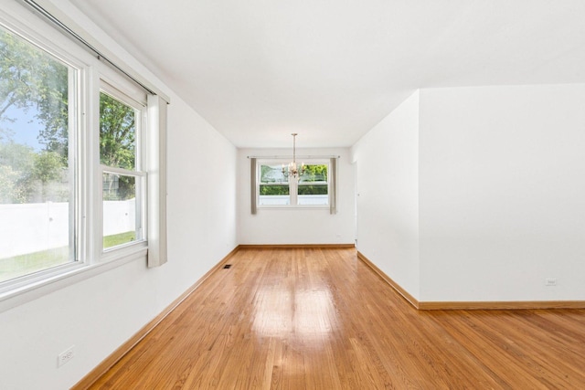 1946 Briarcliffe Blvd, Wheaton, IL 60189 - unfurnished room featuring light wood-style flooring and a chandelier
