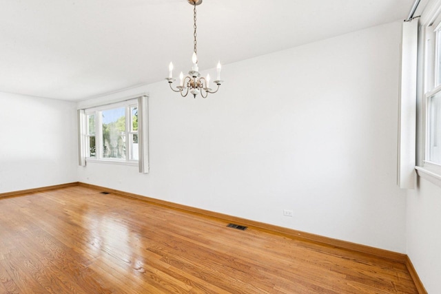 1946 Briarcliffe Blvd, Wheaton, IL 60189 - spare room with a chandelier and wood finished floors