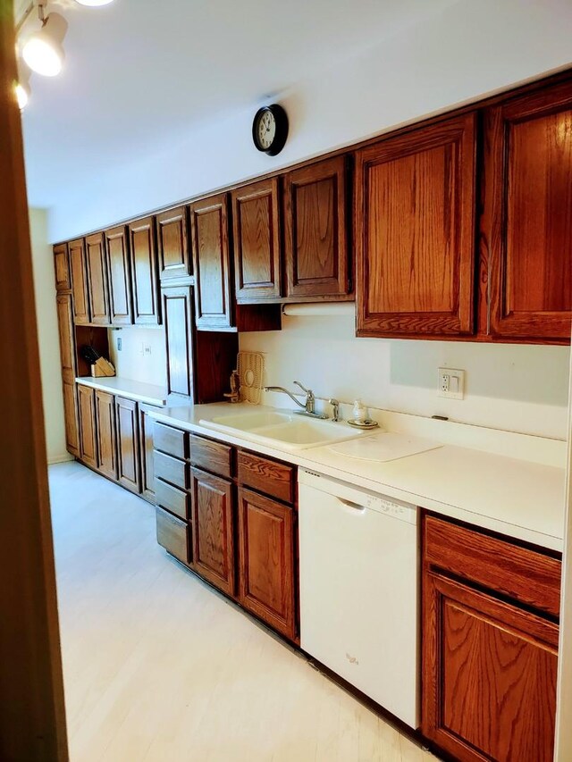 1175 Lake Cook Rd Unit 201W, Northbrook, IL 60062 - kitchen featuring white dishwasher, a sink, light countertops, and light flooring
