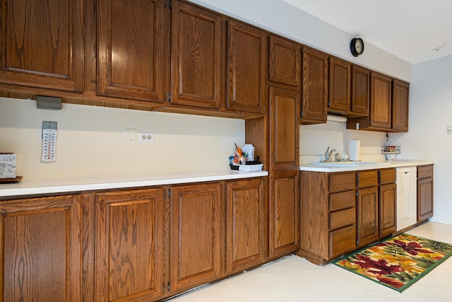 1175 Lake Cook Rd Unit 201W, Northbrook, IL 60062 - kitchen with a sink, light countertops, dishwasher, and brown cabinetry