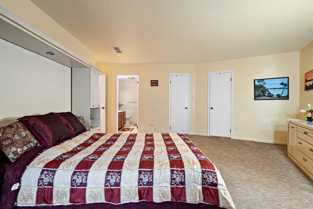 1175 Lake Cook Rd Unit 201W, Northbrook, IL 60062 - bedroom featuring light colored carpet, baseboards, and ensuite bath