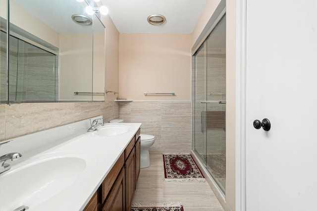 1175 Lake Cook Rd Unit 201W, Northbrook, IL 60062 - bathroom with toilet, double vanity, tile walls, a shower stall, and a wainscoted wall