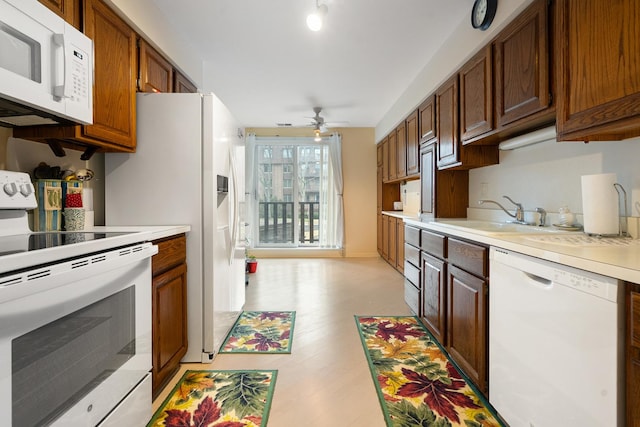 1175 Lake Cook Rd Unit 201W, Northbrook, IL 60062 - kitchen featuring white appliances, a sink, light countertops, and a ceiling fan
