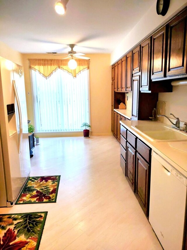 1175 Lake Cook Rd Unit 201W, Northbrook, IL 60062 - kitchen featuring a sink, white appliances, light countertops, and healthy amount of natural light