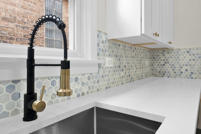 7535 S Aberdeen St, Chicago, IL 60620 - kitchen view of light countertops, white cabinets, tasteful backsplash, and a sink