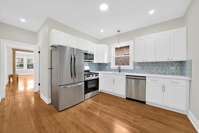 7535 S Aberdeen St, Chicago, IL 60620 - kitchen with appliances with stainless steel finishes, a sink, light countertops, light wood-style flooring, and recessed lighting