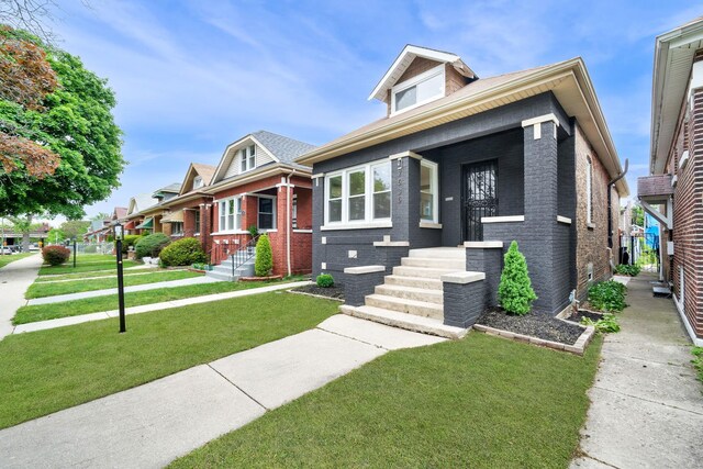 7535 S Aberdeen St, Chicago, IL 60620 - view of front of house with brick siding, a front yard, and a residential view