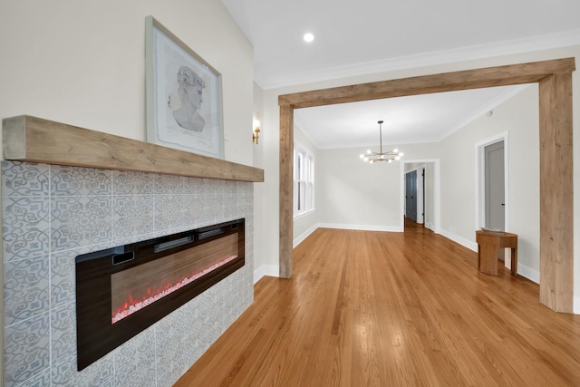 7535 S Aberdeen St, Chicago, IL 60620 - unfurnished living room featuring a glass covered fireplace, a chandelier, crown molding, wood finished floors, and baseboards