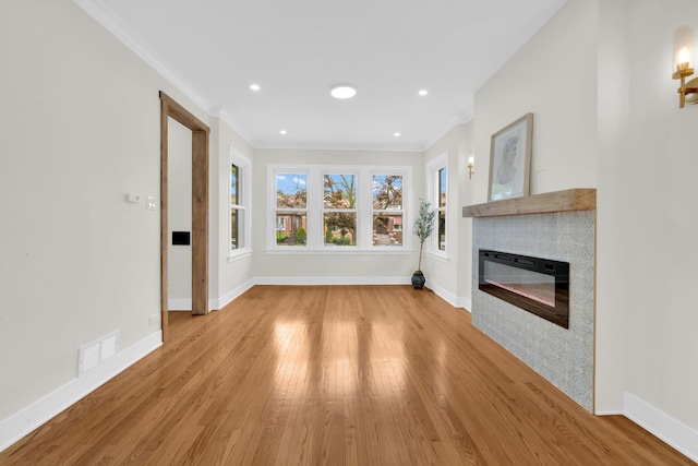 7535 S Aberdeen St, Chicago, IL 60620 - unfurnished living room featuring ornamental molding, wood finished floors, a glass covered fireplace, baseboards, and recessed lighting