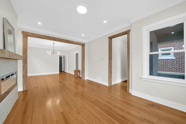 7535 S Aberdeen St, Chicago, IL 60620 - unfurnished living room with a chandelier, crown molding, light wood finished floors, baseboards, and recessed lighting