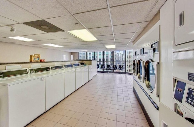 10 E Ontario St Unit 4805, Chicago, IL 60611 - community laundry with washer and clothes dryer, stacked washer / dryer, and light tile patterned floors