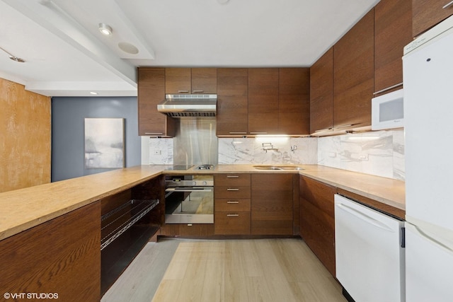 10 E Ontario St Unit 4805, Chicago, IL 60611 - kitchen featuring white appliances, under cabinet range hood, backsplash, and light countertops
