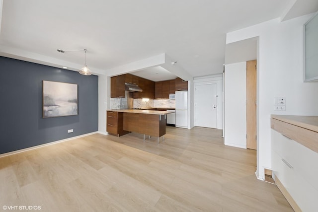 10 E Ontario St Unit 4805, Chicago, IL 60611 - kitchen featuring light countertops, white appliances, under cabinet range hood, a peninsula, and tasteful backsplash