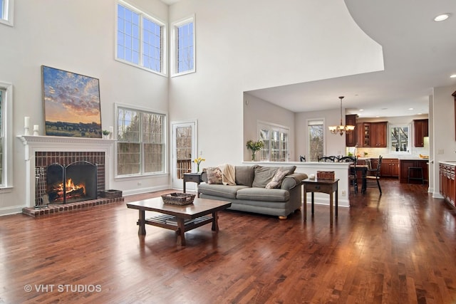 4824 Darlene Ct E, Long Grove, IL 60047 - living area featuring a chandelier, dark wood-type flooring, a brick fireplace, a high ceiling, and recessed lighting