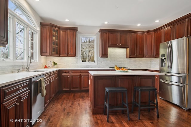 4824 Darlene Ct E, Long Grove, IL 60047 - kitchen with appliances with stainless steel finishes, a sink, light countertops, a kitchen island, and backsplash