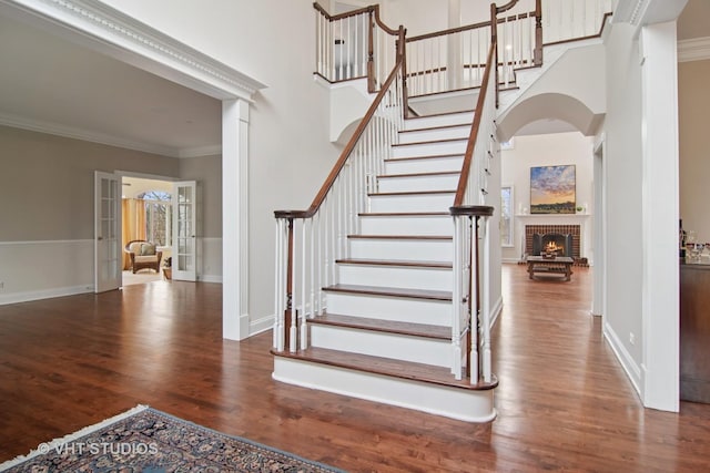 4824 Darlene Ct E, Long Grove, IL 60047 - stairway with wood finished floors, crown molding, a fireplace, a high ceiling, and baseboards