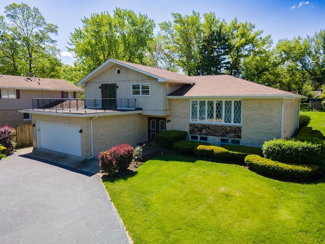 533 Lomond Dr, Mundelein, IL 60060 - split level home featuring driveway, a front yard, brick siding, an attached garage, and a balcony